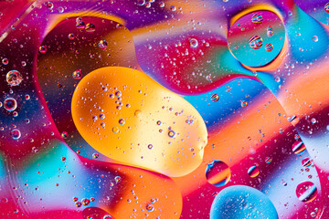 Macro oil and water multi colored abstract background.  holiday postcard background. oil drops on...