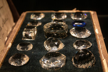 Box with jewelry and crystal transparent stones. Processed clear white quartz amethyst. Close up photo of gemstone background texture