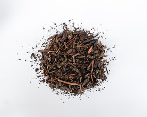 Dried unbrewed black tea leaves isolated on white background