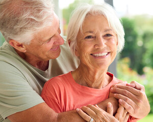 Head And Shoulders Of Loving Senior Couple On Hugging Indoors At Home Together