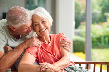 Head And Shoulders Of Loving Senior Couple On Hugging Indoors At Home Together