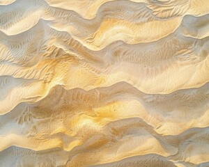 top view of textured sand with waves and light colors