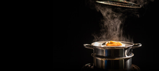 A boiling pot steams up as a chef opens the lid of a pot, cooking steam food in a restaurant.
