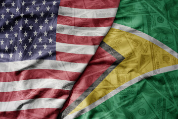 big waving colorful flag of united states of america and national flag of guyana on the dollar money background. finance concept.