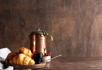 traditional breakfast with croissants and jam