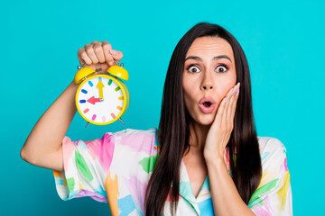 Photo of pretty young woman open mouth hold alarm wear shirt isolated on teal color background