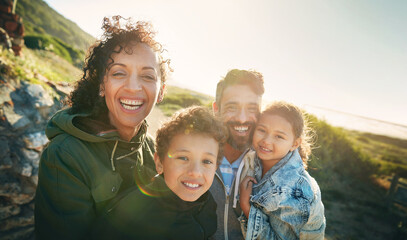 Holiday, mountain and portrait of family with smile, nature and outdoor bonding together on travel adventure. Mom, dad and children on summer vacation with hiking, happy face and sunshine on hill