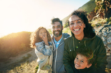 Vacation, mountain and outdoor portrait of family with smile, nature and bonding together on travel adventure. Mom, dad and children on summer holiday with hiking, happy face and sunshine on hill
