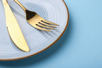 Setting with stylish cutlery on light blue table, closeup. Space for text