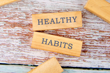 Business and Healthy habits concept. Concept word Healthy habits on wooden blocks on old boards