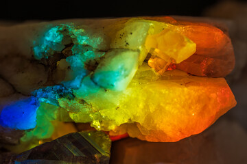 natural quartz rock with embedded gems in prism light