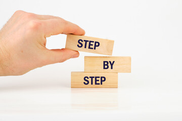 Concept Step by Step text on wooden blocks on a white background