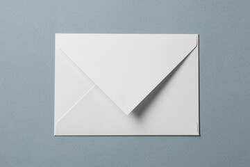 Letter envelope on grey background, top view