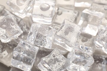 Melting ice cubes with water drops as background, above view