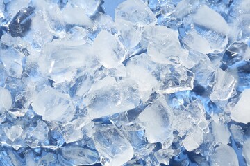 Pieces of crushed ice on light blue background, above view