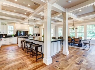 Beautiful kitchen in luxury home with island and columns stock photo