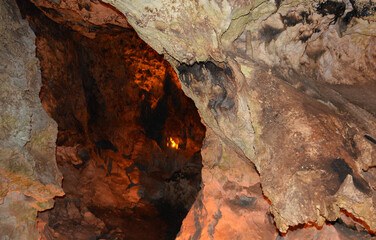 a cave with a hole in the middle of it with light   
