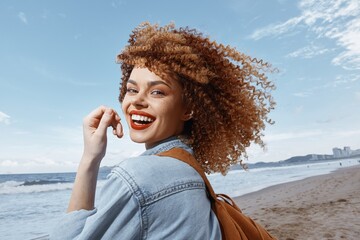 Smiling Woman with Backpack, Enjoying a Happy Vacation on a Beach