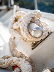 Ship rope is securely tied with a cleat hitch to a horn cleat, showcasing the durability and...
