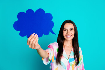 Photo of positive lovely woman wear stylish print clothes hold paper card empty space isolated on cyan color background