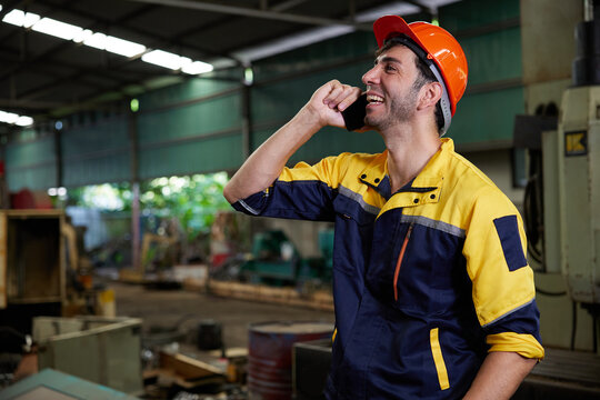 engineer or technician talking and calling on smartphone in the factory