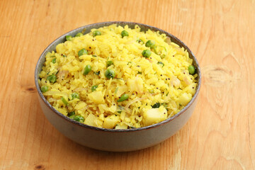 Indian Breakfast Dish Poha Also Know as Pohe or Aalu poha made up of Beaten Rice or Flattened Rice. The rice flakes are lightly fried in oil with mustard,