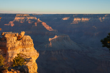 Breathtaking view of Grand Canyon at sunrise or sunset. Intricate layers showcase rugged terrain...
