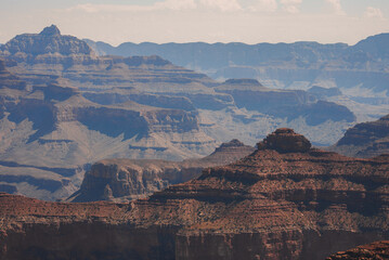 Majestic, layered landscape of the Grand Canyon in Arizona, showcasing stunning geological formations with intricate patterns in red, brown, and beige rock.