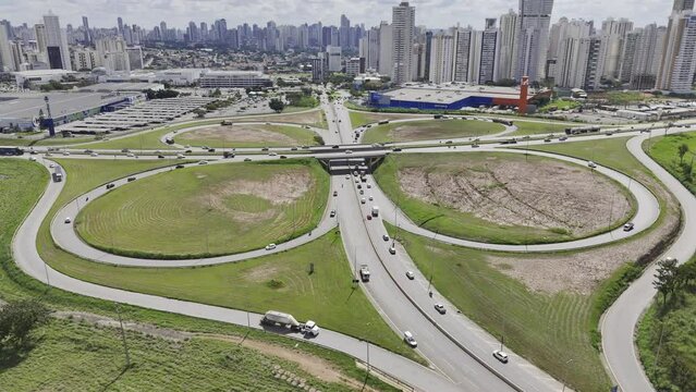 Drone orbits to left over cloverleaf highway in Goiania, Brazil