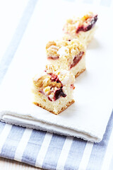 Sliced ​​yeast cake on bright background. Close up. Copy space.
