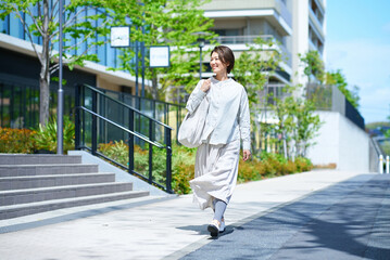 ショッピングバッグを持って街を歩く女性