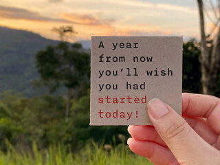 A year from now you'll wish you had started today text note with nature background. Stock photo.