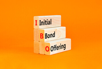 Naklejka premium IBO initial bond offering symbol. Concept words IBO initial bond offering on beautiful wooden blocks. Beautiful orange background. Business IBO initial bond offering concept. Copy space.