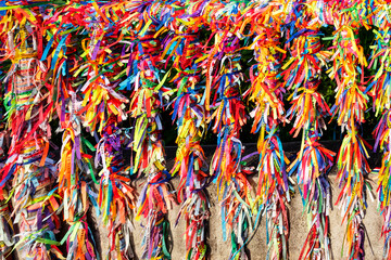 Colorful cloth ribbons used as bracelets with the belief of attracting protection and good luck,  Arraial D'Ajuda, Bahia, Brazil, Feb 2022