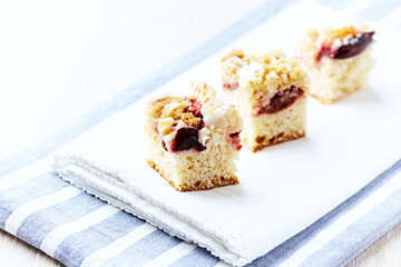 Sliced ​​yeast cake on bright background. Close up. Copy space.