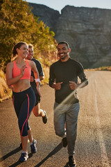People, group and mountain running for cardio exercise with friends or morning workout, nature or...
