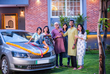 Indian asian family buys new car and standing for photograph wit