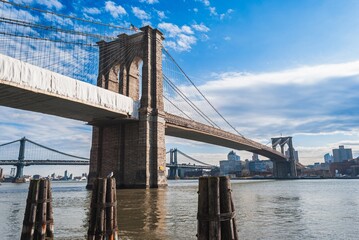 The Brooklyn Bridge is a large suspension bridge that spans the East River