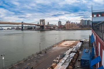 A city view of the water with a bridge in the background