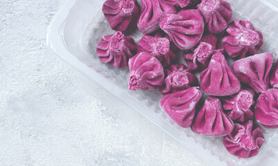 freshly frozen beetroot khinkali, in a container, top view, no people,