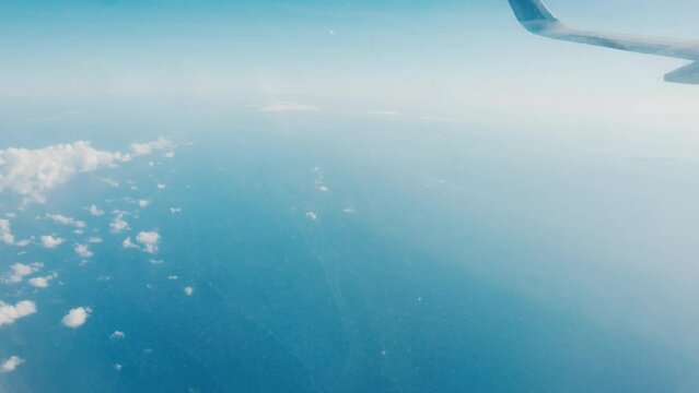 Window view from the airplane flying over Indonesia
