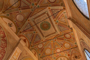 The ceiling of a Certosa di Pavia  Monastery is decorated with a variety of designs and patterns....