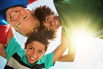 Friends, low angle and portrait of children on camp for friendship, playing and fun together. Diversity, youth and boys huddle in circle for childhood, game and hug for school, recess and playground