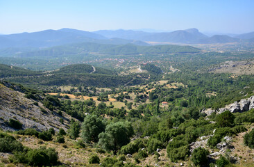 Obraz premium a view of a valley with a town and mountains in the background