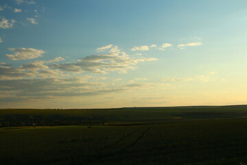 Fototapeta premium A landscape with a road and blue sky with clouds