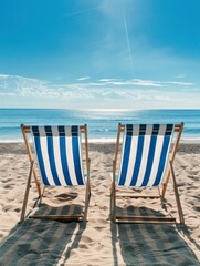 Two blue and white striped deck chairs sat on the beach, with the sun shining down