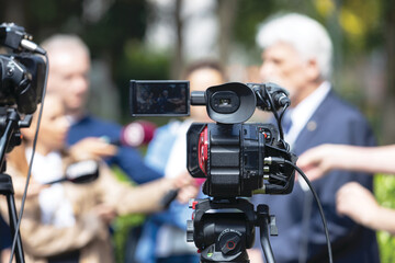 Filming media event with a video camera. TV interview or news conference. Public relations - PR...