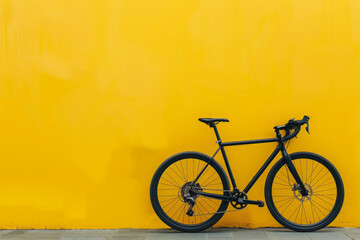Gravel bike on yellow background with copy space. Road sport bike, close up. Minimalist backdrop with bicycle