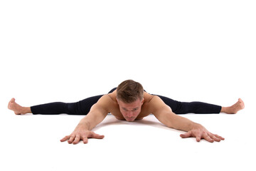 A young attractive man with an athletic body is doing fitness. White background.