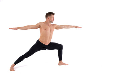 Fototapeta na wymiar A young attractive man with an athletic body is doing yoga. White background.